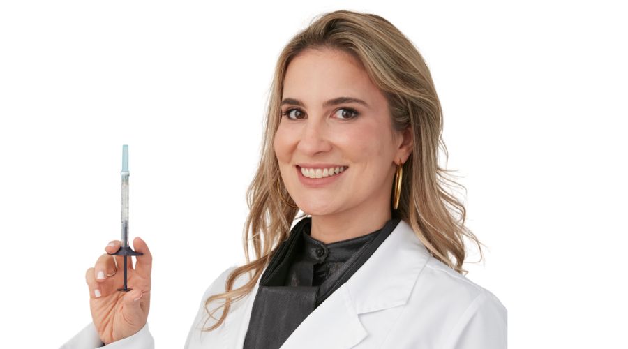 Dr. Maia with a syringe of cheek filler.