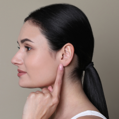young brunette woman touching her ear