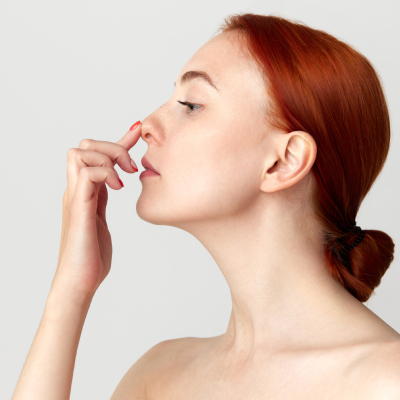 beautiful redhead female touching her nose