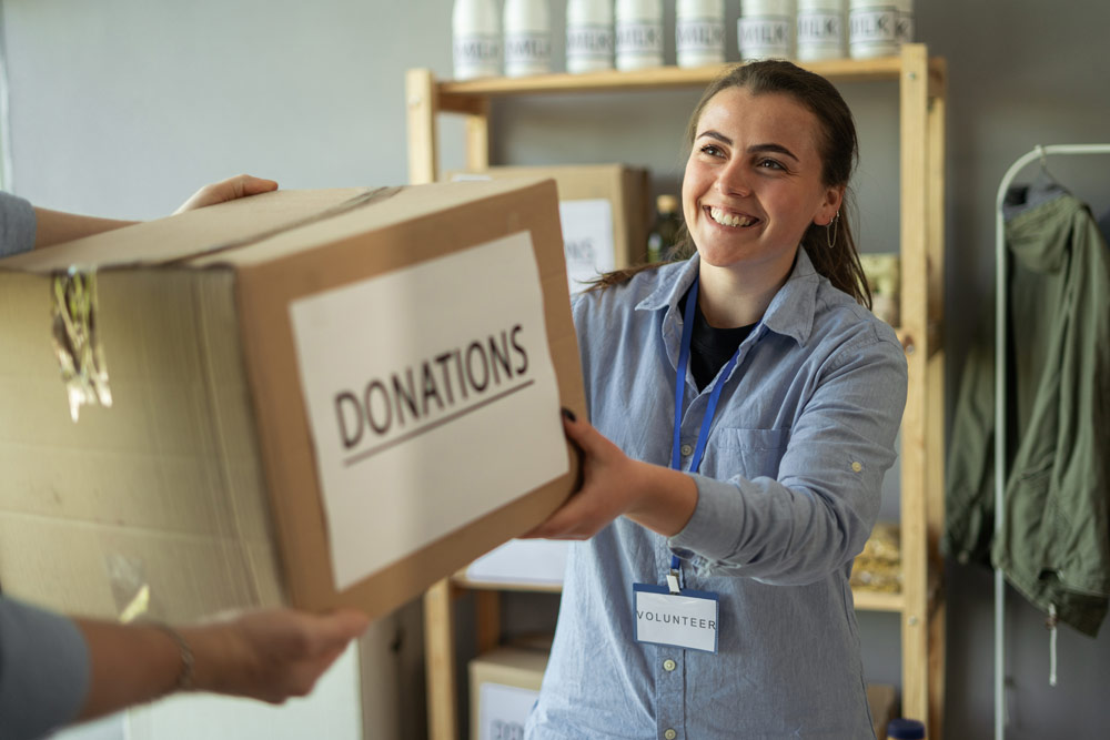 Volunteers Giving Box Of Food