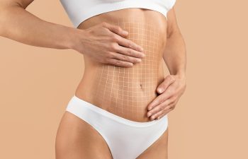 Close-up of a person's midsection in white underwear with a white digital grid overlaid on the stomach, against a beige background.